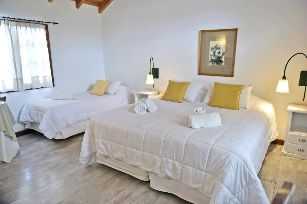Habitación con cama king y balcón en Hostería Plaza Mayor